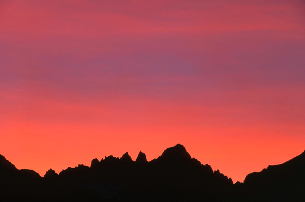 Mt. Whitney backlit by colorful sunset, as seen from Owens Valley, Eastern Sierra, CA